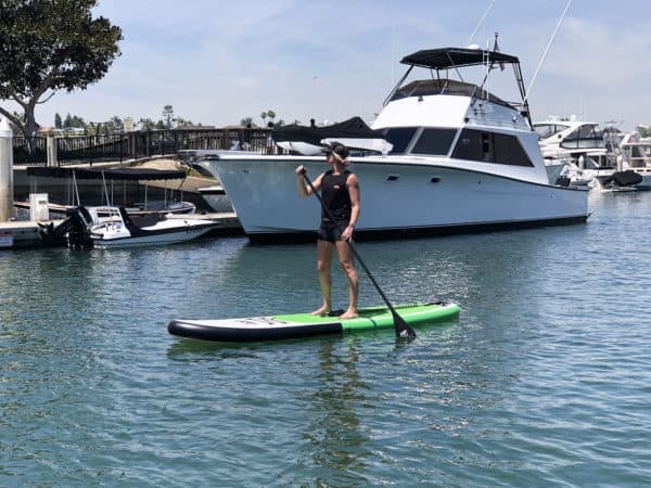 Inflatable POP Paddle Board Green:Black beside yacht