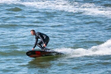 Onean Carver X Electric Jetboard with guy in a wet suit 1 scaled 1